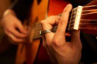 A Man Playing an Acoustic Guitar